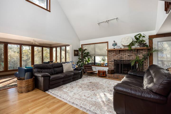 Shared living room with fireplace and river-facing windows