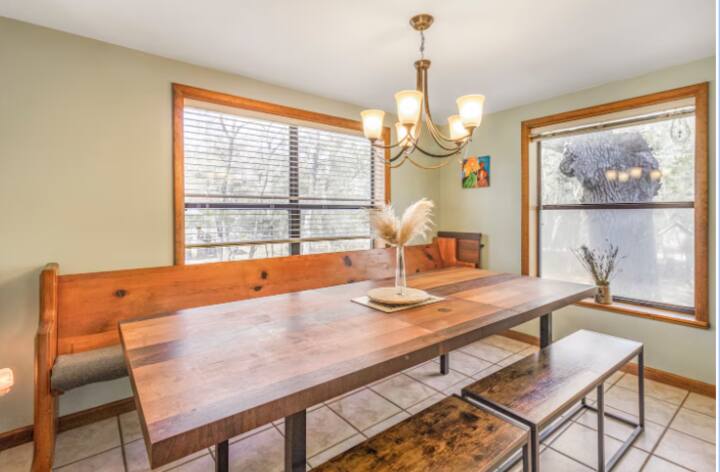 Shared dining area with a long wood table